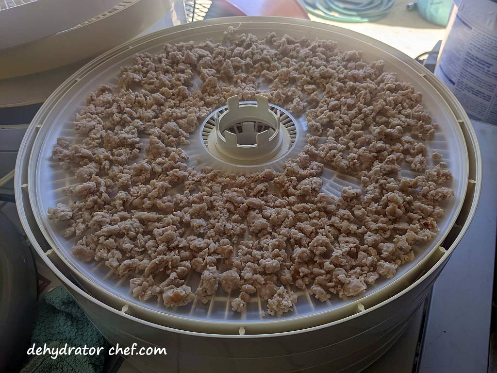 cooked ground pork on a dehydrator tray