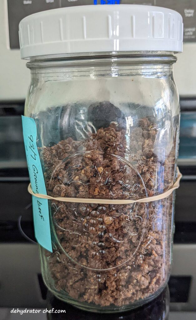 equalizing and conditioning the dehydrated ground beef in a quart-size clear mason jar with a tight-fitting lid