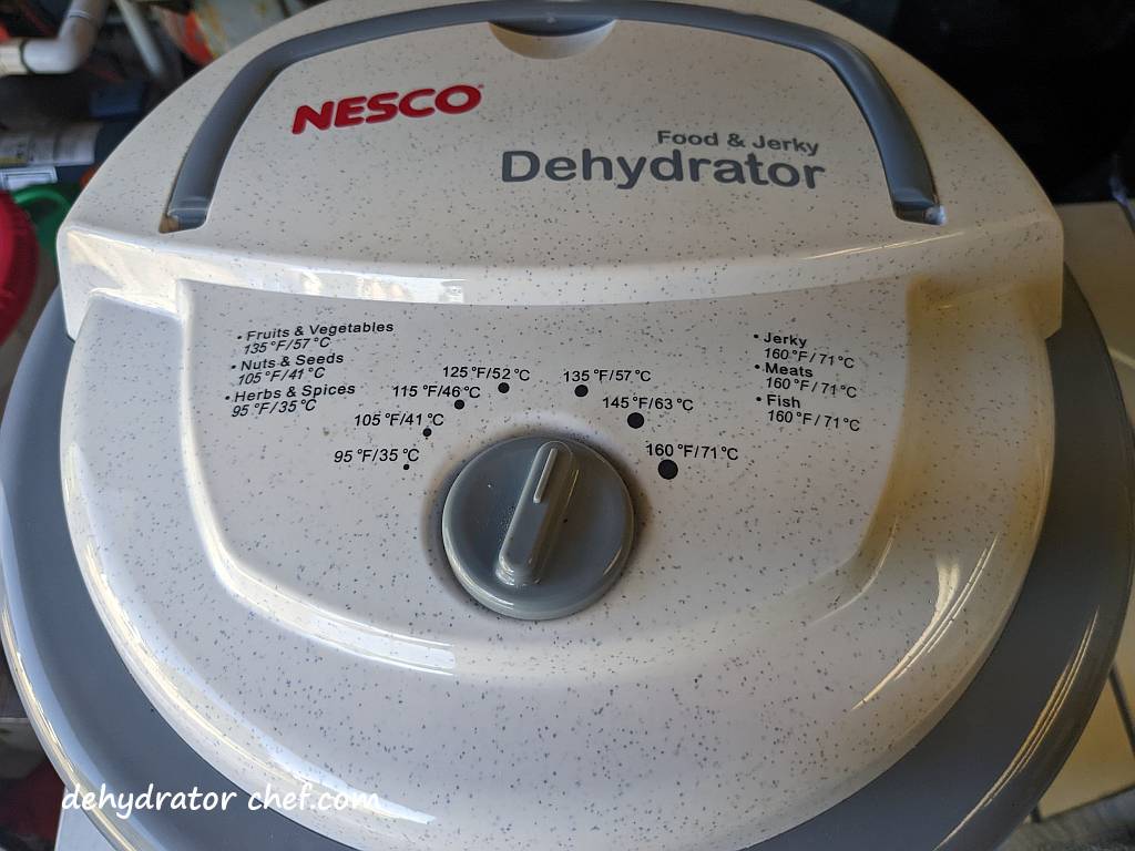 The dehydrator temperature control is set to 135 °F (57 °C) to dehydrate parsley