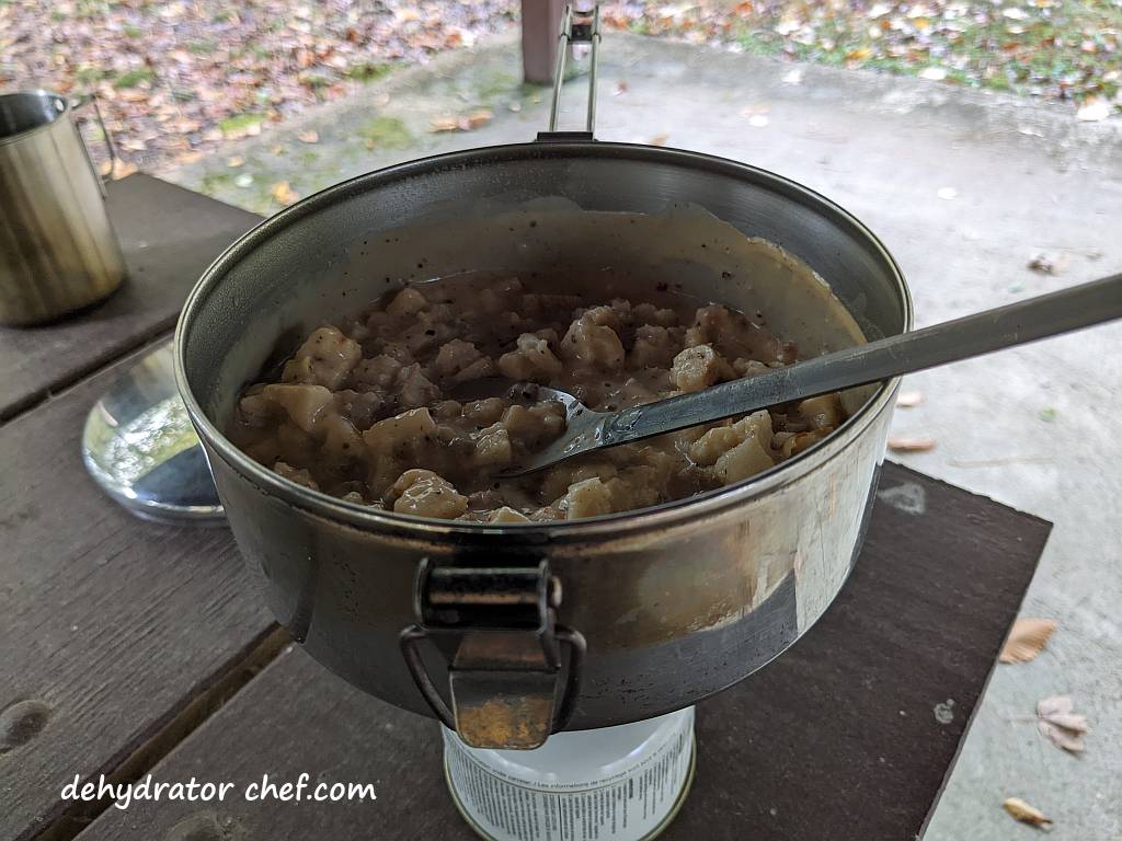 biscuits and gravy homemade dehydrated backpacking meal in a 1.1 liter sized MSR Alpine stainless steel stowaway camping pot and a TOAKS titanium long-handled spoon | making dehydrated meals for camping | homemade dehydrated meal recipes | make your own dehydrated camping food | homemade dehydrated camping meals | homemade dehydrated backpacking meals