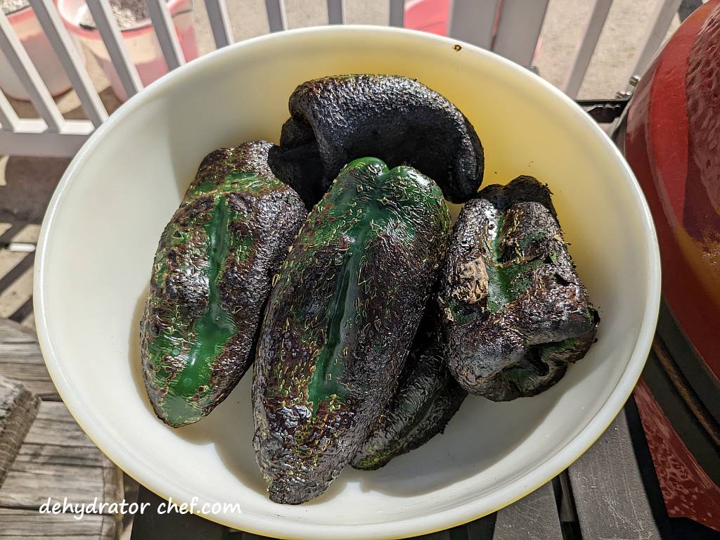 fire-roasted poblano peppers in a large bowl and ready for the next step of steaming