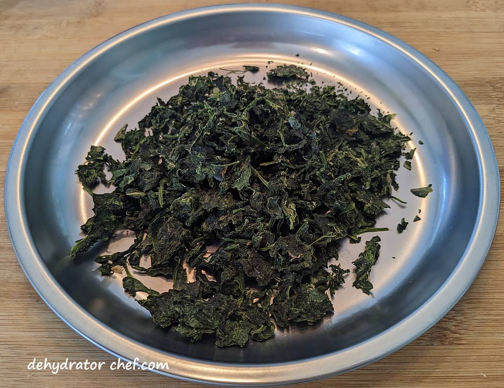 dehydrated spinach on a metal camping plate | | dehydrating frozen spinach | dehydrated frozen spinach | dehydrating spinach | dehydrated spinach | best foods to dehydrate for long term storage | dehydrating food for long term storage | dehydrated food recipes for long term storage | dehydrating meals for long term storage | food dehydrator for long term storage