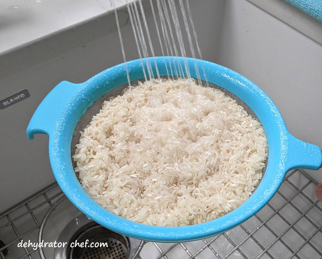 rinsing white rice under running water to remove surface starch and dust | | dehydrating white rice | dehydrated white rice | best foods to dehydrate for long term storage | dehydrating food for long term storage | dehydrated food recipes for long term storage | dehydrating meals for long term storage | food dehydrator for long term storage