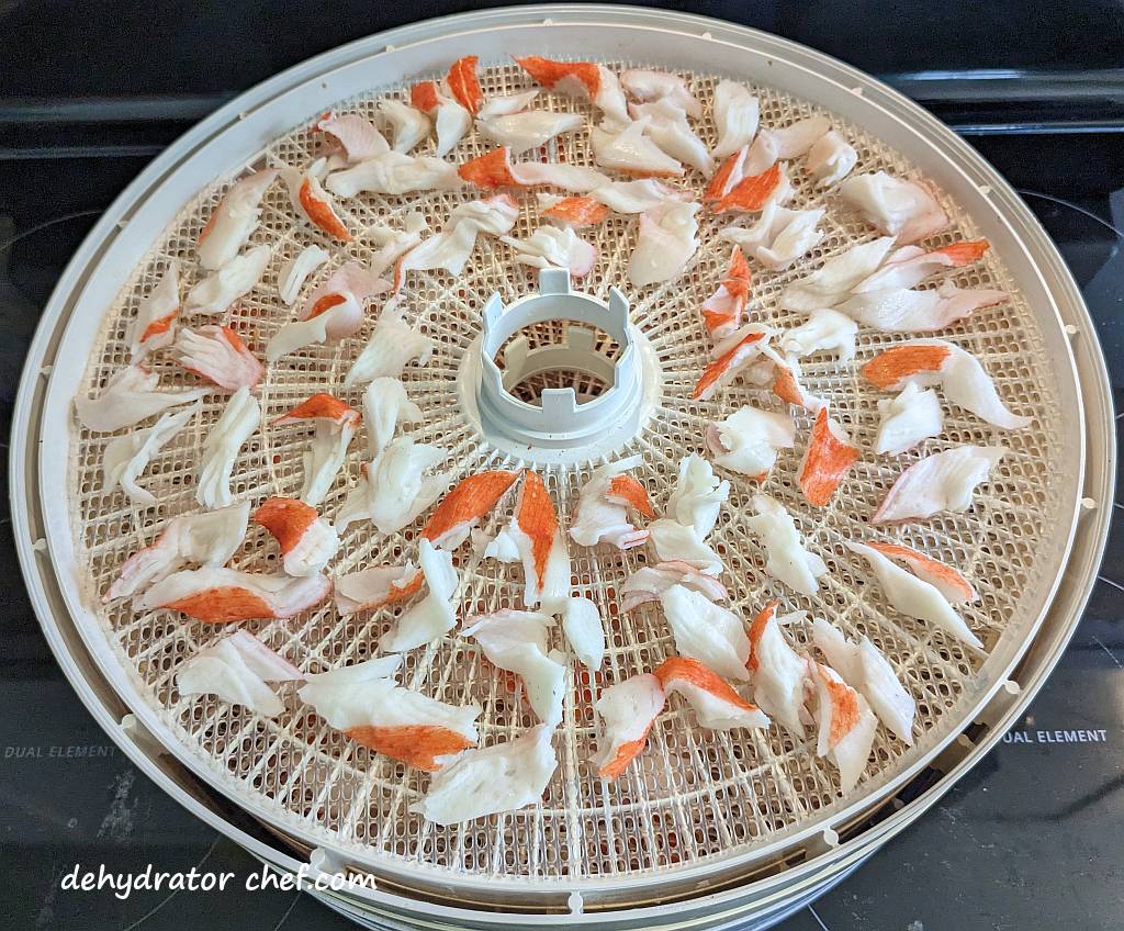 imitation crab meat on a dehydrator tray | | dehydrated imitation crab meat | dehydrating imitation crab meat | how to dehydrate imitation crab meat | best foods to dehydrate for long term storage | dehydrating food for long term storage | dehydrated food recipes for long term storage | dehydrating meals for long term storage | food dehydrator for long term storage | making dehydrated meals for camping | homemade dehydrated meal recipes | make your own dehydrated camping food | homemade dehydrated camping meals | homemade dehydrated backpacking meals