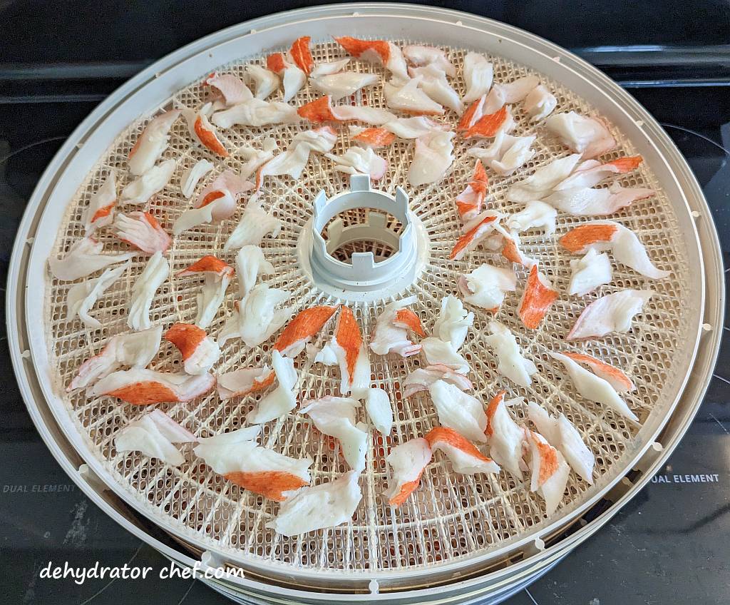 imitation crab meat on a dehydrator tray | dehydrated imitation crab meat | dehydrating imitation crab meat | how to dehydrate imitation crab meat | best foods to dehydrate for long term storage | dehydrating food for long term storage | dehydrated food recipes for long term storage | dehydrating meals for long term storage | food dehydrator for long term storage | making dehydrated meals for camping | homemade dehydrated meal recipes | make your own dehydrated camping food | homemade dehydrated camping meals | homemade dehydrated backpacking meals