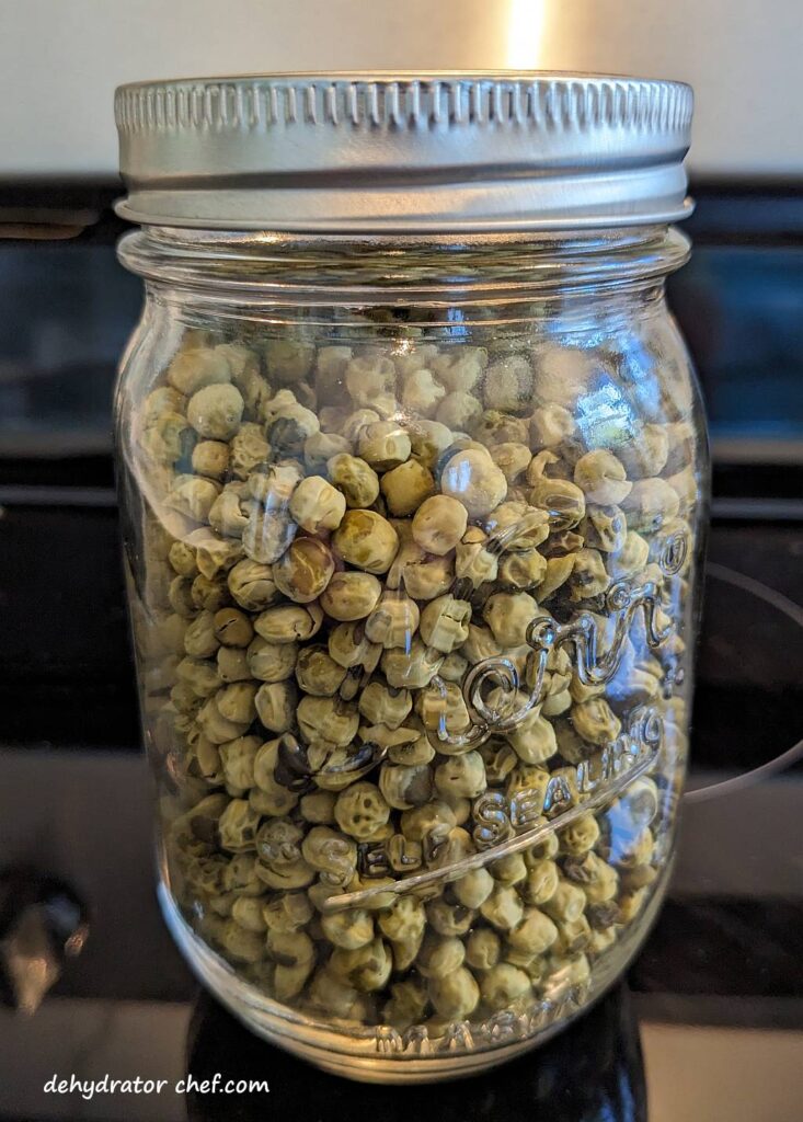 conditioning dried peas in a one pint canning jar | dehydrating canned peas | dehydrated peas | best foods to dehydrate for long term storage | dehydrating food for long term storage | dehydrated food recipes for long term storage | dehydrating meals for long term storage | food dehydrator for long term storage