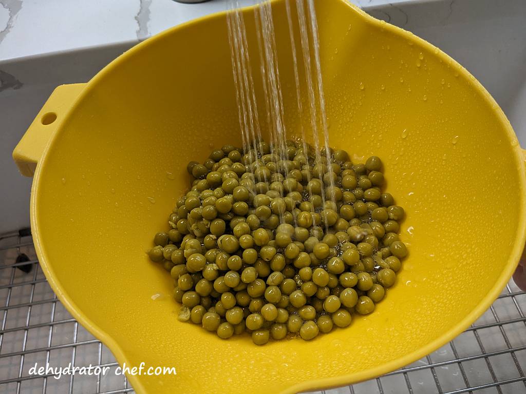rinsing peas under water | dehydrating canned peas | dehydrated peas | best foods to dehydrate for long term storage | dehydrating food for long term storage | dehydrated food recipes for long term storage | dehydrating meals for long term storage | food dehydrator for long term storage