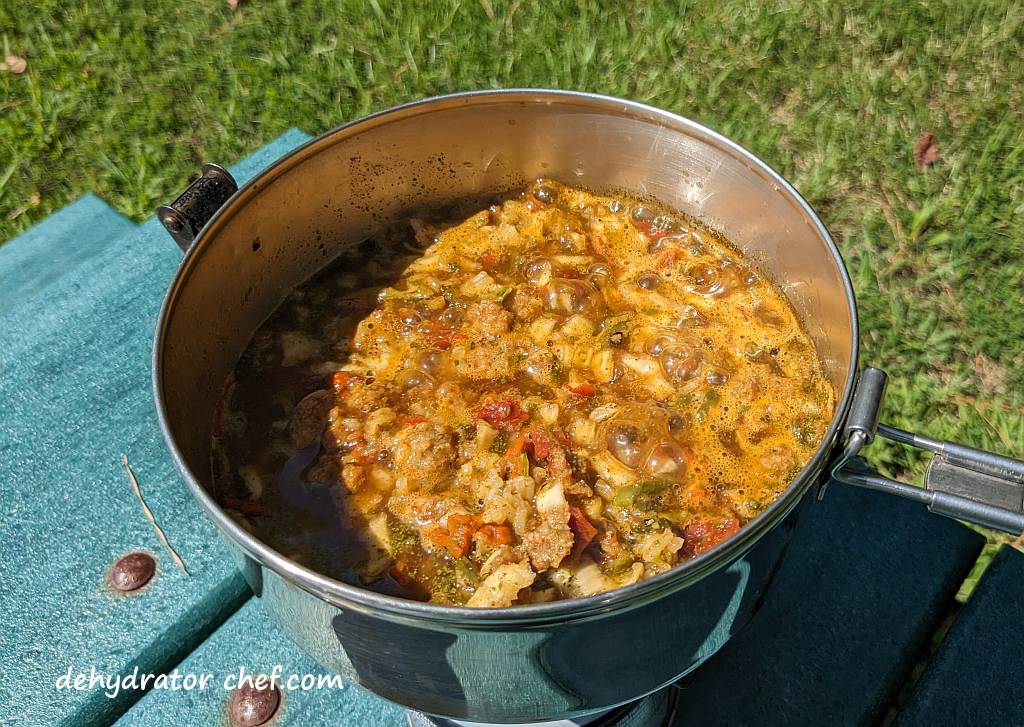 The dehydrated pork taco with Mexican rice mix is coming to a boil. The ingredients are softening and begin to release their flavors.  We'll give it another stir and turn it down to a low simmer for another couple of minutes before wrapping it all up in a cozy to steam and finish hydrating into a tasty camping meal.