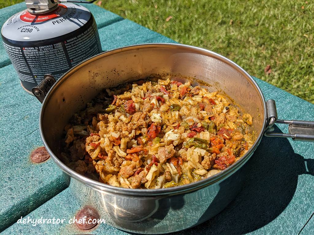 The reconstituted pork taco with Mexican rice is ready to eat.  Eat straight from the cooking pot or scoop a big helping into a tortilla wrap or pita pocket bread.