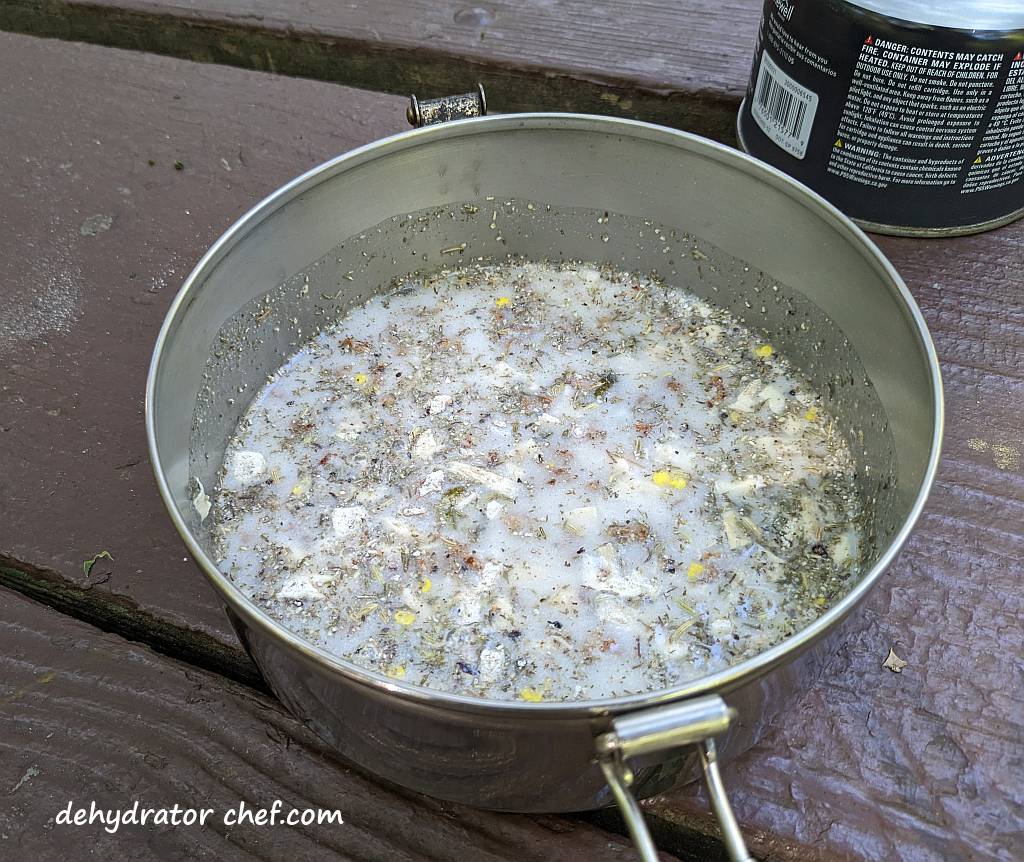 sausage gravy with water added in a cooking pot | dehydrated sausage gravy in pita pocket bread | making dehydrated meals for camping | homemade dehydrated meal recipes | make your own dehydrated camping food | homemade dehydrated camping meals | homemade dehydrated backpacking meals