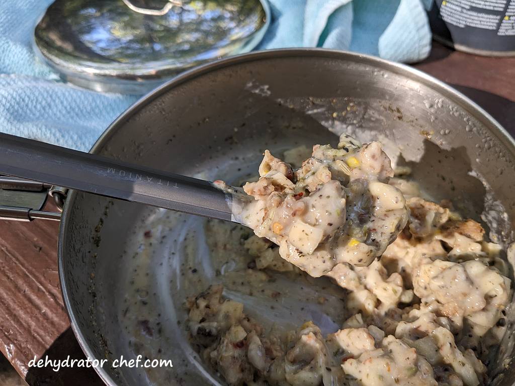 scooping the sausage gravy into pita pockets | dehydrated sausage gravy in pita pocket bread | making dehydrated meals for camping | homemade dehydrated meal recipes | make your own dehydrated camping food | homemade dehydrated camping meals | homemade dehydrated backpacking meals