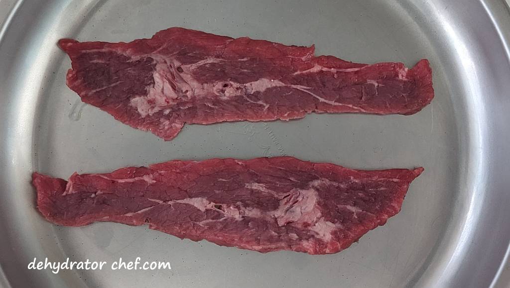 beef stir fry strips on a plate how to make beef jerky | best foods to dehydrate for long term storage | dehydrating food for long term storage | dehydrated food recipes for long term storage | dehydrating meals for long term storage | food dehydrator for long term storage