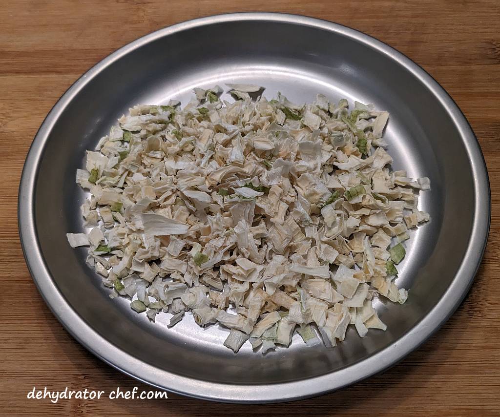 dehydrated onions on a camping plate | dehydrating onions | dehydrated onions | best foods to dehydrate for long term storage | dehydrating food for long term storage | dehydrated food recipes for long term storage | dehydrating meals for long term storage | food dehydrator for long term storage
