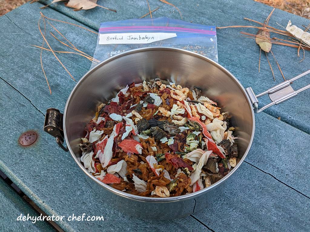 Shown is the dehydrated seafood jambalaya in a cooking pot. That finishes Step 1, adding the dry mix to the cooking pot. | Dehydrated seafood jambalaya in the cooking pot. | Dehydrated seafood jambalaya recipe. | The best foods to dehydrate for long term storage. | Dehydrating food for long term storage. | Dehydrated food recipes for long term storage. | Dehydrating meals for long term storage. | Using a food dehydrator for long term storage.