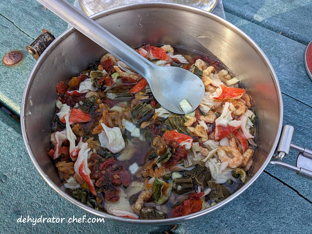 Shown is Step 2, where we covered the dry mix with water to reconstitute it and gave everything a good stir every couple of minutes. It's important to keep the contents in contact with the water. | We are rehydrating the seafood jambalaya for five minutes. | Dehydrated seafood jambalaya recipe. | The best foods to dehydrate for long term storage. | Dehydrating food for long term storage. | Dehydrated food recipes for long term storage. | Dehydrating meals for long term storage. | Using a food dehydrator for long term storage.