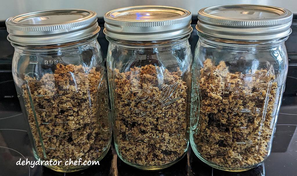 in step 5, equalizing and conditioning, the dehydrated quinoa in quart-sized canning jars | dehydrating quinoa | dehydrated quinoa | best foods to dehydrate for long term storage | dehydrating food for long term storage | dehydrated food recipes for long term storage | dehydrating meals for long term storage | food dehydrator for long term storage