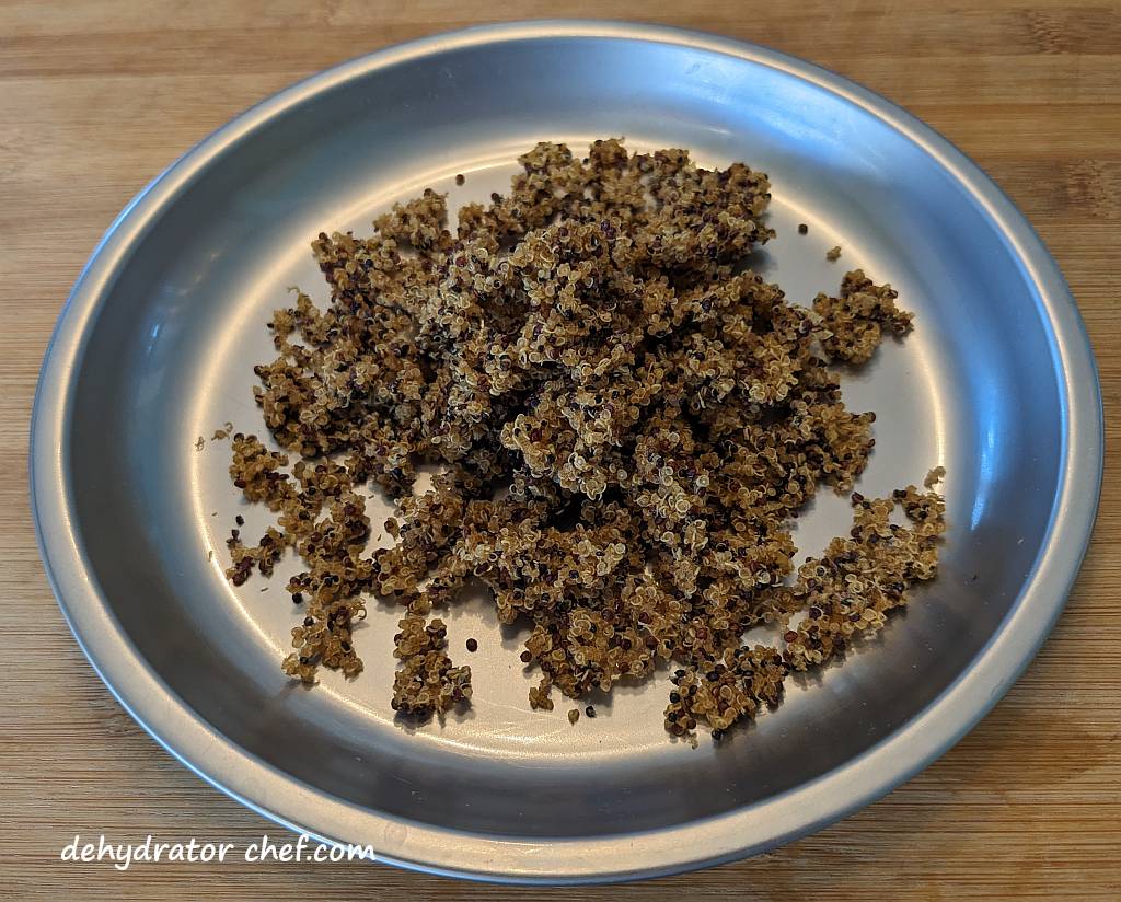 this is 45 grams of dehydrated quinoa shown of a metal camping plate