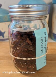 We're at step 6, storing our dehydrated chipotle peppers in adobo sauce using a 1-pint clear canning jar with an added desiccant packet for moisture control.