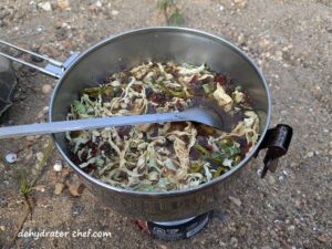 adding water to the dehydrated ground beef and cabbage in our cooking pot