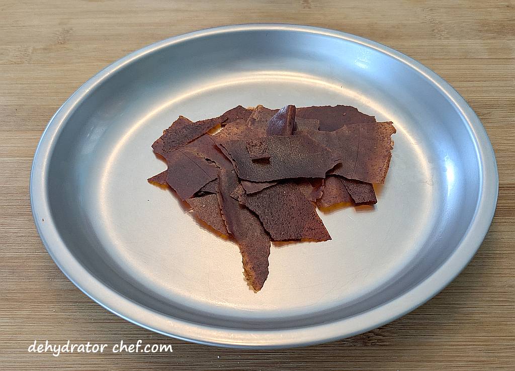 This is 15 grams of dehydrated enchilada sauce, which is approximately one-half of a 10-ounce can that we started with. We’ll break these bigger pieces into smaller fragments before putting it all into a clear canning jar for long-term storage.”  class=