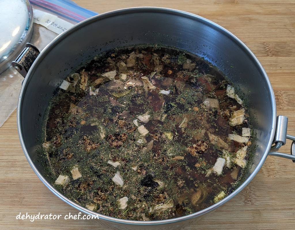 adding water to the dehydrated sweet potato black bean quinoa bowl ingredients in our MSR Stowaway 1.1 liter cooking pot