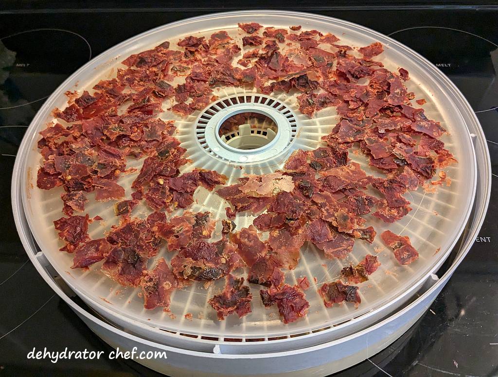 Back on to the dehydrator for several more hours. As I was tearing the leather into small pieces, I found a few tacky areas. So, it all goes back onto the dehydrator for several more hours at 160 °F (71 °C). Dehydrated salsa is done when its brittle and easily snaps in half when bent, much like a potato chip.