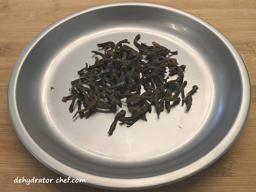 This wrinkled and shriveled dark green pile used to be a 14.5-ounce can of cut green beans. After dehydration, it now weighs only 15 grams. These dehydrated green beans, which are very dark green and shriveled, can be reconstituted in 15 to 20 minutes using one of our Dehydrator Chef recipes.