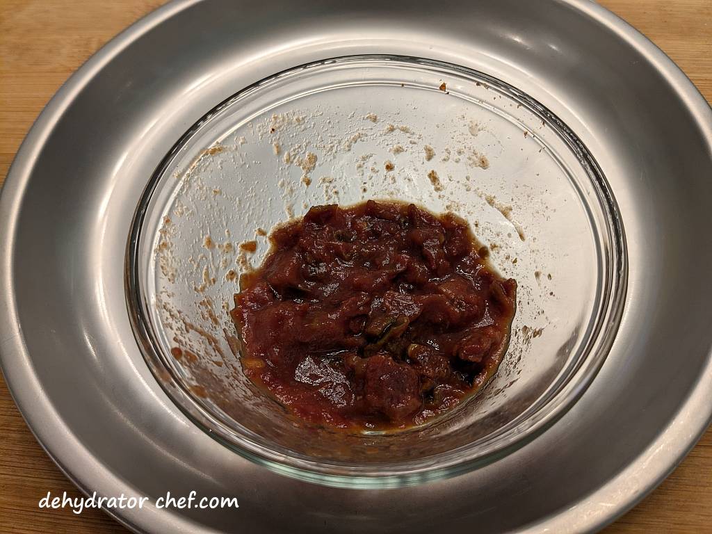 We reconstituted one tablespoon of dehydrated salsa flakes with two tablespoons of room-temperature water. In other words, a 2-to-1 ratio of water to salsa flakes is a starting point. It looks and smells like it's fresh from the jar. I should have made more.