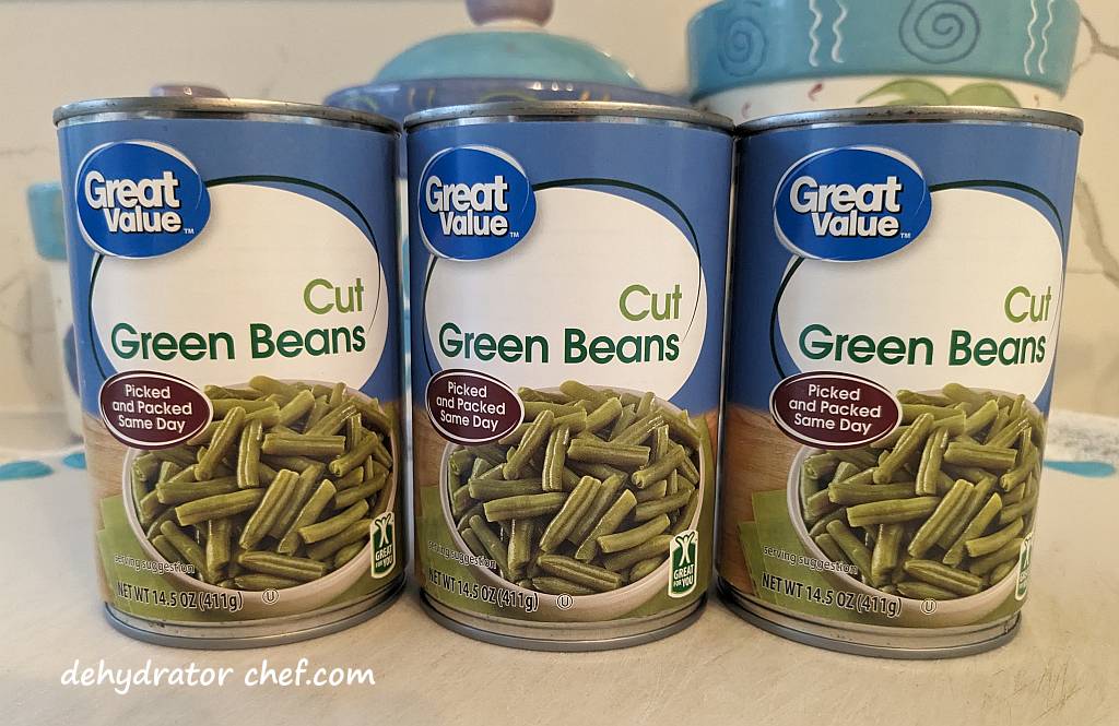 Three cans of cut green beans that we will dry for use in our homemade dehydrated camping meal recipes.