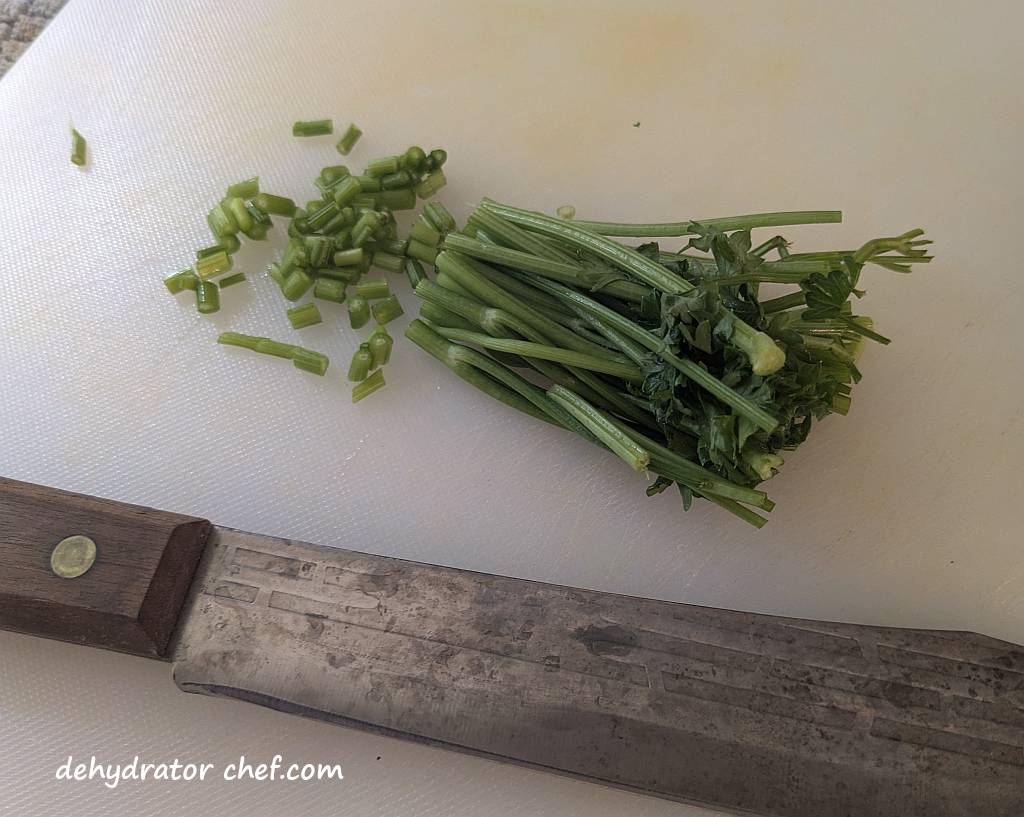 Cutting the parsley stems for dehydration.