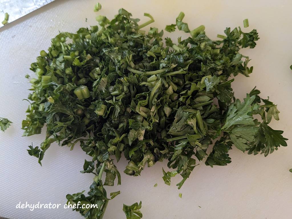 The parsley leaves and smaller stems have been cut and diced into finer pieces for dehydration.