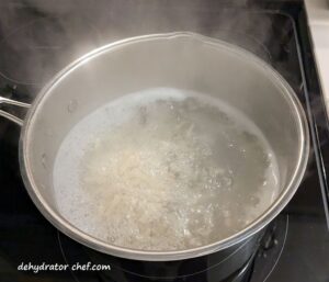 Cooking elbow macaroni so we can dehydrate it for long term storage.