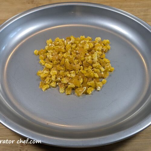 This is one 20-gram serving of dehydrated corn a plate.