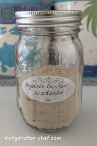 A supply of homemade vegetable bouillon powder in a 1-pint canning jar.