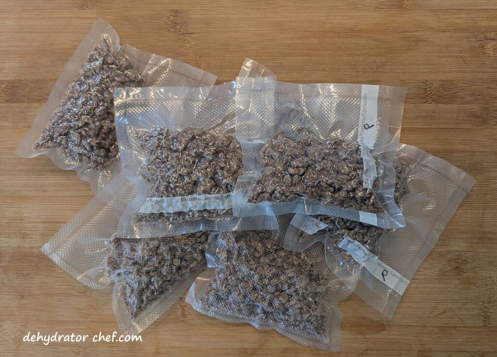 A stash of single-serving dehydrated ground pork crumble packets that we will freeze for future use. We portioned out the pork crumbles into 50-gram single-serving vacuum-sealed packets. Next, we’ll put them all into a large pouch and then vacuum seal it. Finally, it all goes into the freezer and is ready for future use.